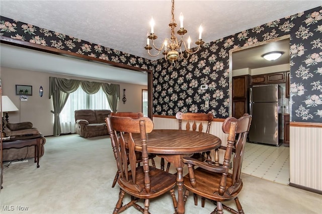 751 Bacon Rd, Oh, OH 44077 - dining space with wallpapered walls, light carpet, a chandelier, a textured ceiling, and a wainscoted wall