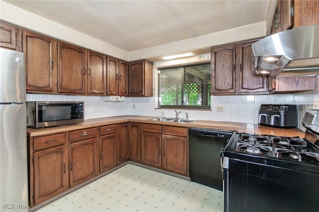 751 Bacon Rd, Oh, OH 44077 - kitchen with appliances with stainless steel finishes, exhaust hood, light flooring, decorative backsplash, and light countertops