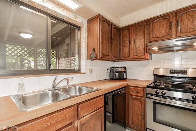 751 Bacon Rd, Oh, OH 44077 - kitchen with stainless steel gas range oven, under cabinet range hood, dishwasher, decorative backsplash, and brown cabinetry