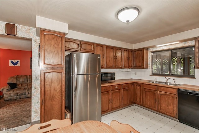 751 Bacon Rd, Oh, OH 44077 - kitchen featuring stainless steel appliances, light countertops, brown cabinets, and tasteful backsplash