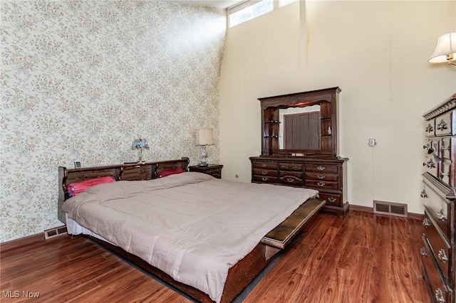 751 Bacon Rd, Oh, OH 44077 - bedroom featuring wood finished floors, wallpapered walls, and a high ceiling