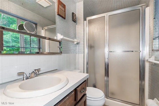 751 Bacon Rd, Oh, OH 44077 - full bathroom with a shower stall, vanity, backsplash, and tile walls