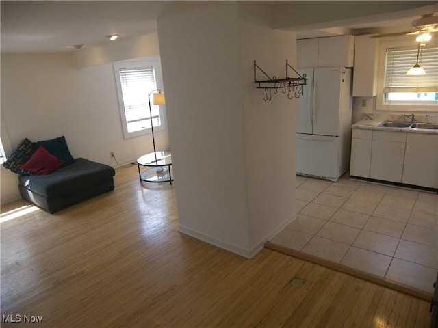 24 E 220th St E, Euclid, OH 44123 - kitchen featuring freestanding refrigerator, light wood-type flooring, and plenty of natural light
