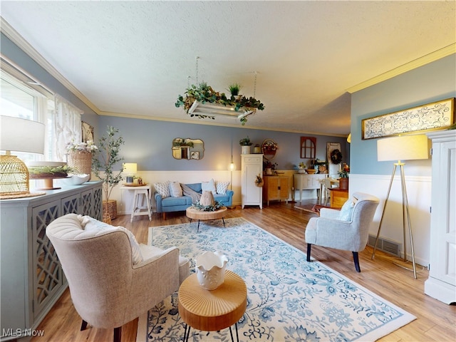 14003 Highview Dr, Dalton, OH 44618 - living room with ornamental molding, wood finished floors, a textured ceiling, and a wainscoted wall