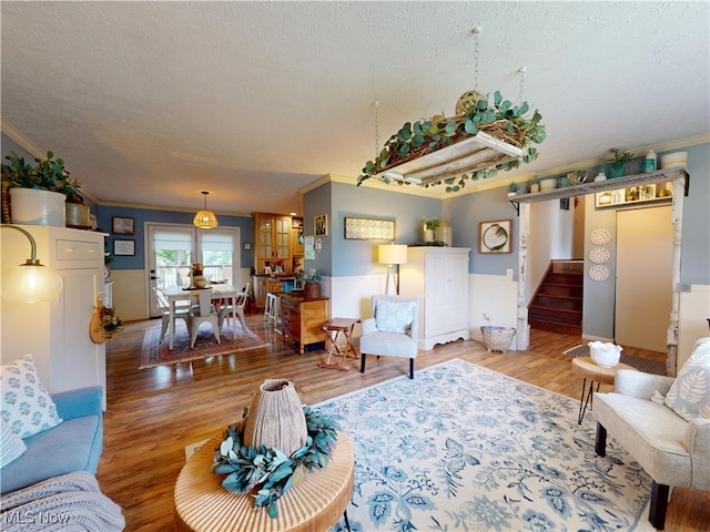 14003 Highview Dr, Dalton, OH 44618 - living room with crown molding, a textured ceiling, wood finished floors, and stairway