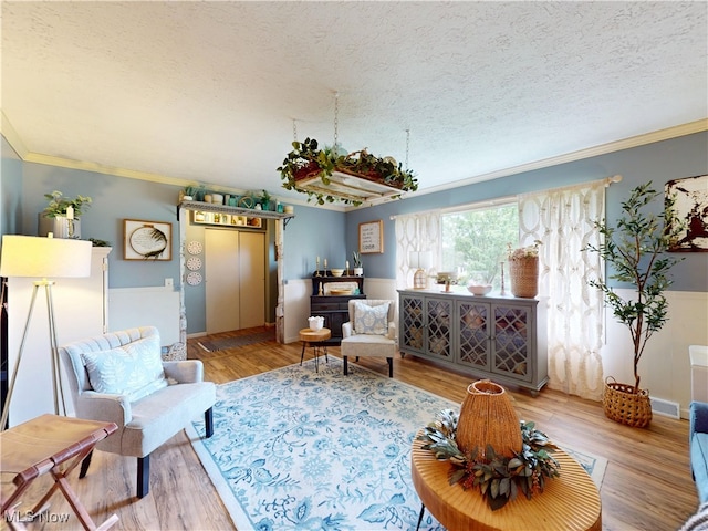 14003 Highview Dr, Dalton, OH 44618 - living room featuring a textured ceiling, crown molding, wood finished floors, and wainscoting