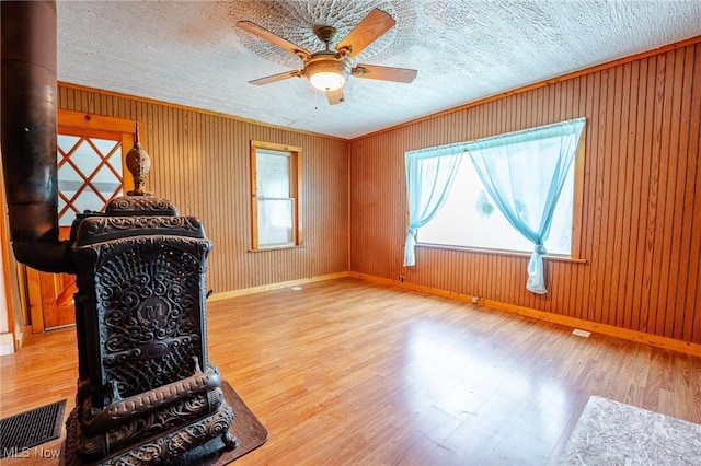 55225 Township Road 224, Fresno, OH 43824 - unfurnished living room featuring ceiling fan, wood finished floors, crown molding, and wood walls
