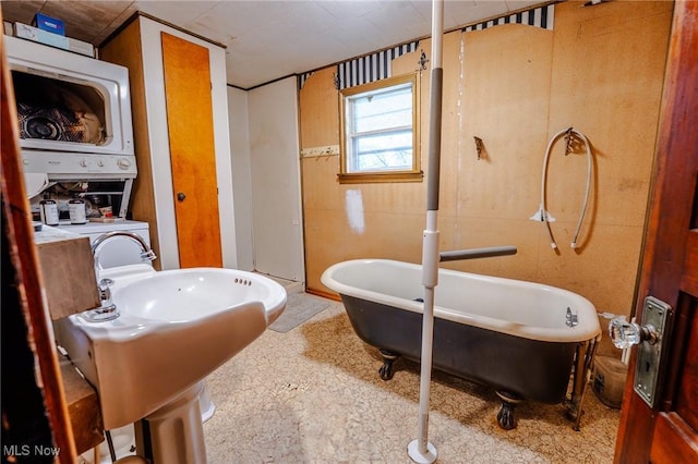 55225 Township Road 224, Fresno, OH 43824 - bathroom with stacked washing machine and dryer and a soaking tub