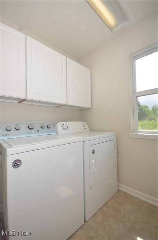 4909 Garnet Cir, Stow, OH 44224 - laundry room featuring cabinet space, washing machine and dryer, and light tile patterned floors