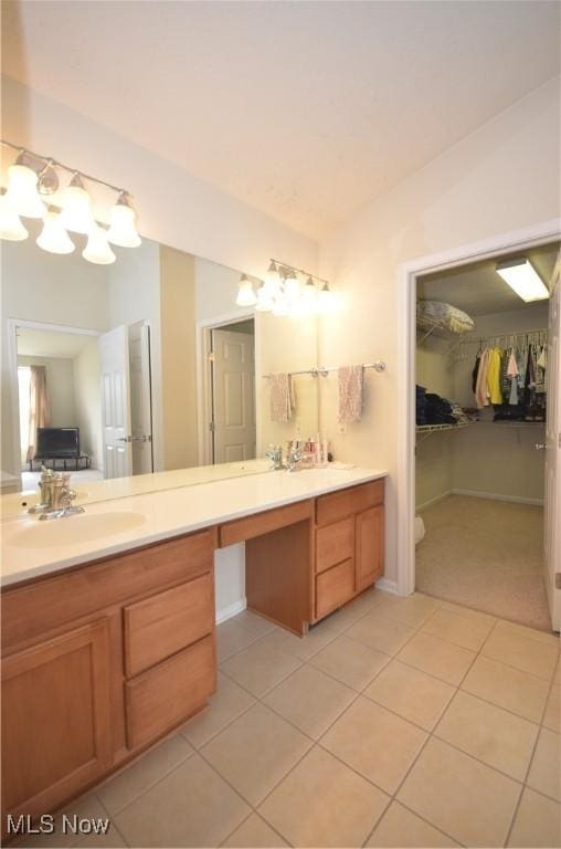 4909 Garnet Cir, Stow, OH 44224 - bathroom with tile patterned flooring, double vanity, a spacious closet, and a chandelier