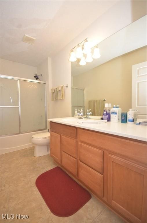 4909 Garnet Cir, Stow, OH 44224 - bathroom featuring tile patterned flooring, vanity, and bath / shower combo with glass door