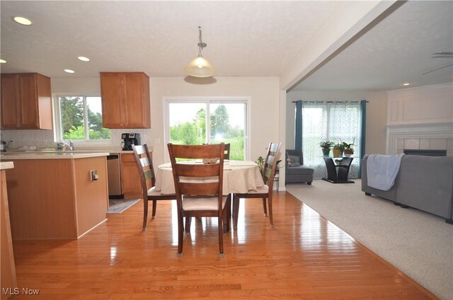 4909 Garnet Cir, Stow, OH 44224 - dining area with plenty of natural light, light wood-type flooring, recessed lighting, and a tile fireplace