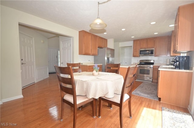 4909 Garnet Cir, Stow, OH 44224 - dining area featuring light wood finished floors, recessed lighting, and wainscoting