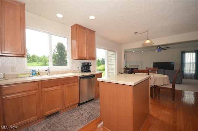 4909 Garnet Cir, Stow, OH 44224 - kitchen featuring stainless steel dishwasher, hardwood / wood-style floors, a fireplace, healthy amount of natural light, and recessed lighting