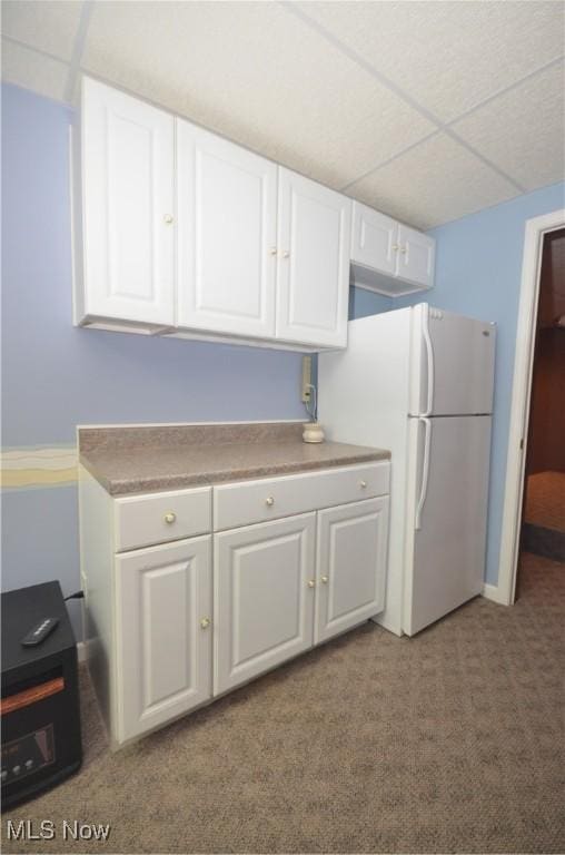 4909 Garnet Cir, Stow, OH 44224 - kitchen with carpet, white cabinets, freestanding refrigerator, a drop ceiling, and light countertops