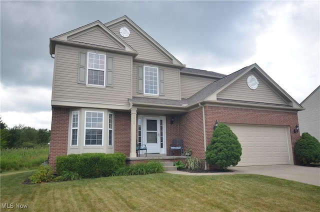 4909 Garnet Cir, Stow, OH 44224 - traditional home with brick siding, concrete driveway, a front lawn, and an attached garage