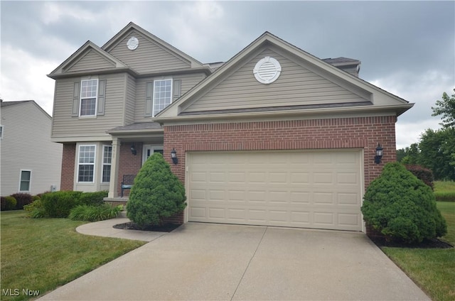 4909 Garnet Cir, Stow, OH 44224 - traditional-style house featuring brick siding, driveway, an attached garage, and a front yard