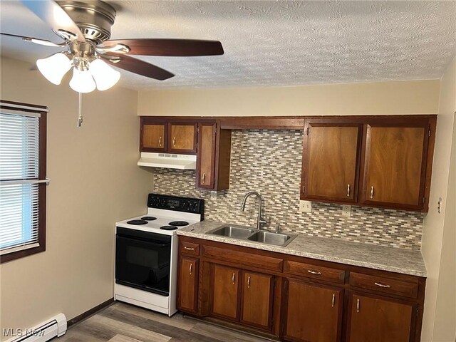 862 Cook Ave, Youngstown, OH 44512 - kitchen with white electric range, under cabinet range hood, baseboard heating, dark wood finished floors, and light countertops