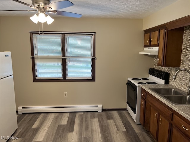 862 Cook Ave, Youngstown, OH 44512 - kitchen with white appliances, under cabinet range hood, a baseboard radiator, a ceiling fan, and decorative backsplash