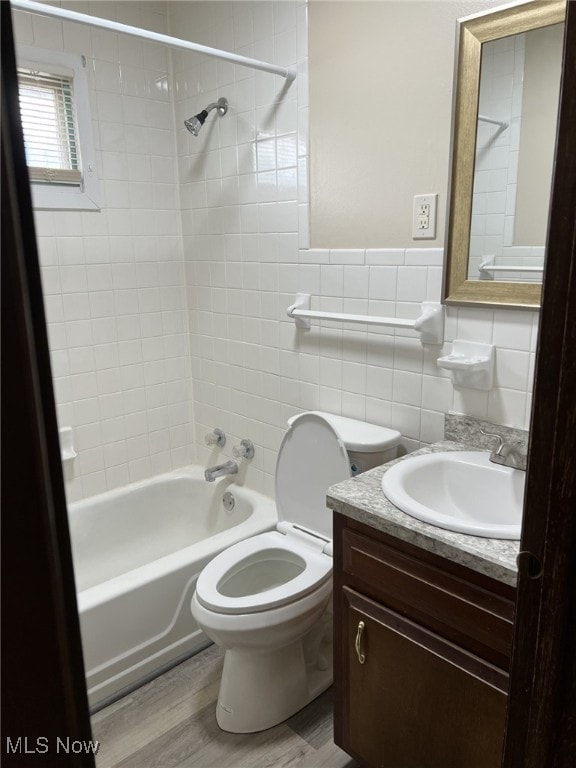 862 Cook Ave, Youngstown, OH 44512 - full bathroom with bathtub / shower combination, tile walls, vanity, and wood finished floors