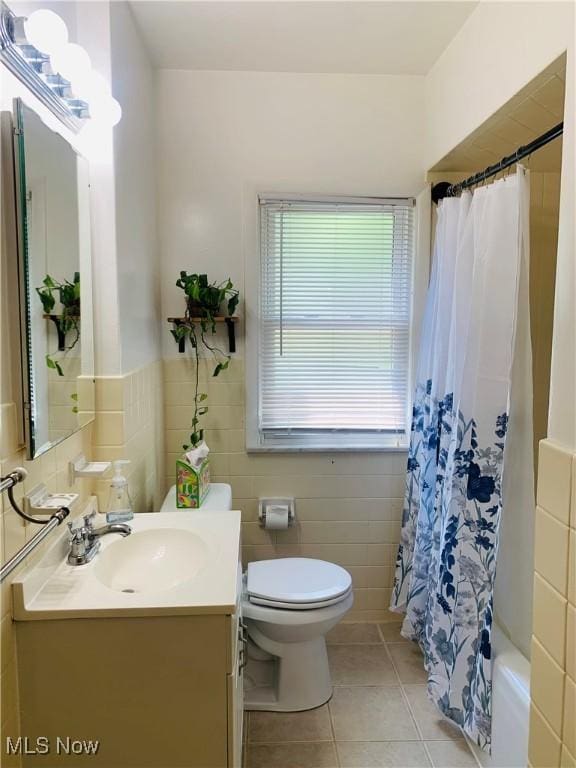 1528 Felton Rd, South Euclid, OH 44121 - bathroom with vanity, tile patterned floors, tile walls, and shower / tub combo with curtain