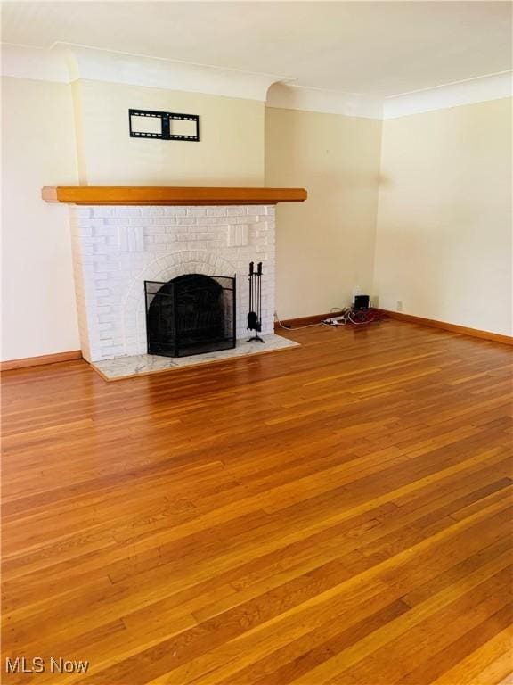 1528 Felton Rd, South Euclid, OH 44121 - unfurnished living room featuring a brick fireplace, ornamental molding, and wood finished floors