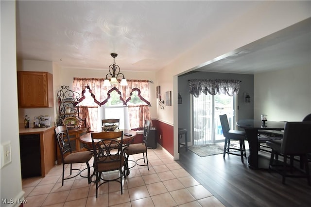 307 Crimson Cir, Campbell, OH 44405 - dining area with a chandelier and light wood-style flooring