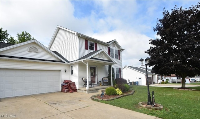 307 Crimson Cir, Campbell, OH 44405 - traditional-style house with covered porch, a front lawn, concrete driveway, and a garage