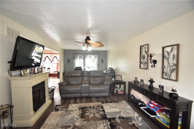 307 Crimson Cir, Campbell, OH 44405 - living room with dark wood-style floors, a glass covered fireplace, and a ceiling fan