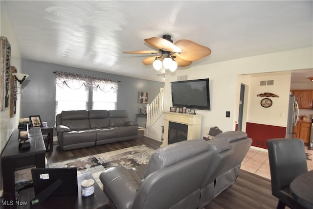 307 Crimson Cir, Campbell, OH 44405 - living room with ceiling fan, wood finished floors, and a glass covered fireplace