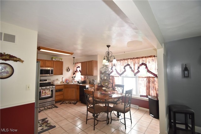 307 Crimson Cir, Campbell, OH 44405 - dining space with a chandelier and light tile patterned floors