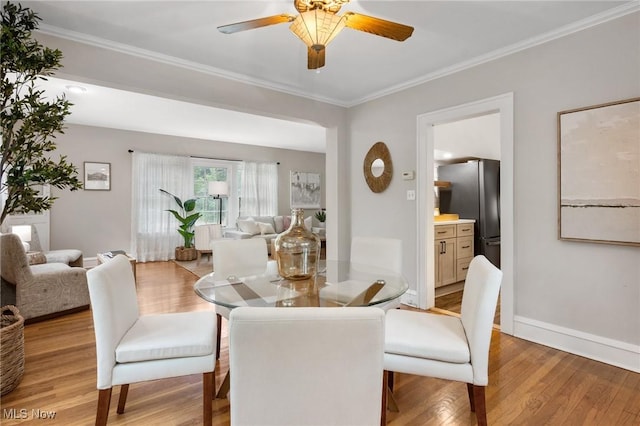 16205 Fernway Rd, Shaker Heights, OH 44120 - dining area with light wood-style flooring, ceiling fan, and ornamental molding