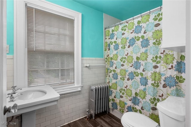16205 Fernway Rd, Shaker Heights, OH 44120 - full bathroom with radiator, tile walls, wood finished floors, a shower with shower curtain, and wainscoting