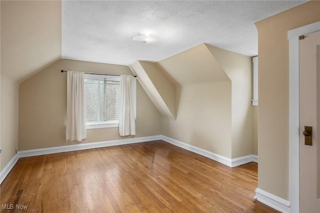 16205 Fernway Rd, Shaker Heights, OH 44120 - bonus room featuring wood-type flooring, lofted ceiling, and a textured ceiling
