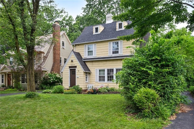 16205 Fernway Rd, Shaker Heights, OH 44120 - view of front facade with a front lawn, roof with shingles, and a chimney