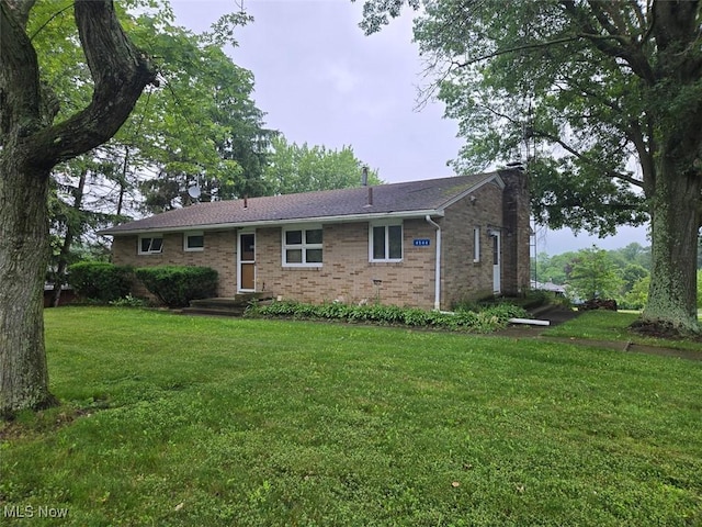 4544 Springvale Ave SW, Canton, OH 44706 - back of property featuring a chimney, brick siding, and a lawn