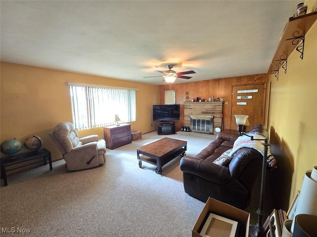 4544 Springvale Ave SW, Canton, OH 44706 - carpeted living area with a ceiling fan, wood walls, and a fireplace