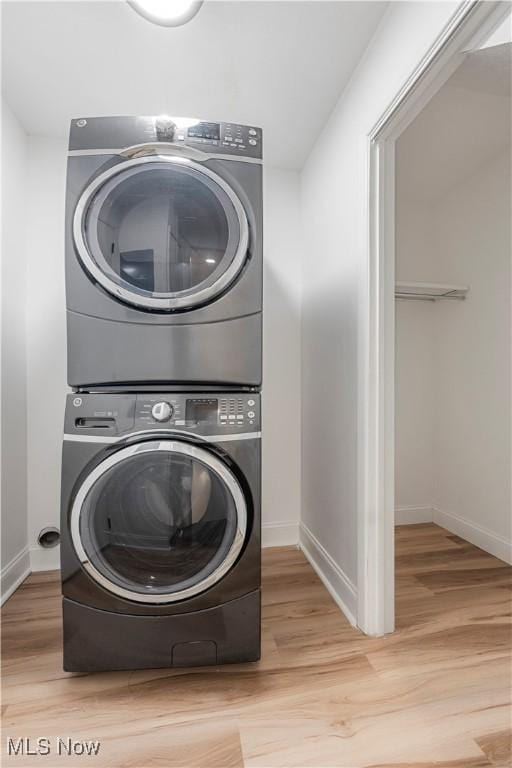 1226 Ramblewood Trl, South Euclid, OH 44121 - laundry area featuring stacked washing machine and dryer and wood finished floors