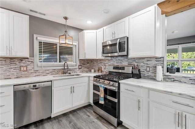 382 Rosemont Ave, Austintown, OH 44515 - kitchen with stainless steel appliances, white cabinets, light wood-style floors, backsplash, and recessed lighting