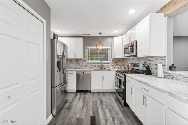 382 Rosemont Ave, Austintown, OH 44515 - kitchen with stainless steel appliances, decorative backsplash, white cabinets, recessed lighting, and pendant lighting