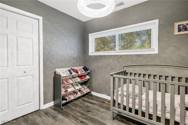 382 Rosemont Ave, Austintown, OH 44515 - bedroom featuring wood finished floors, a crib, and a chandelier