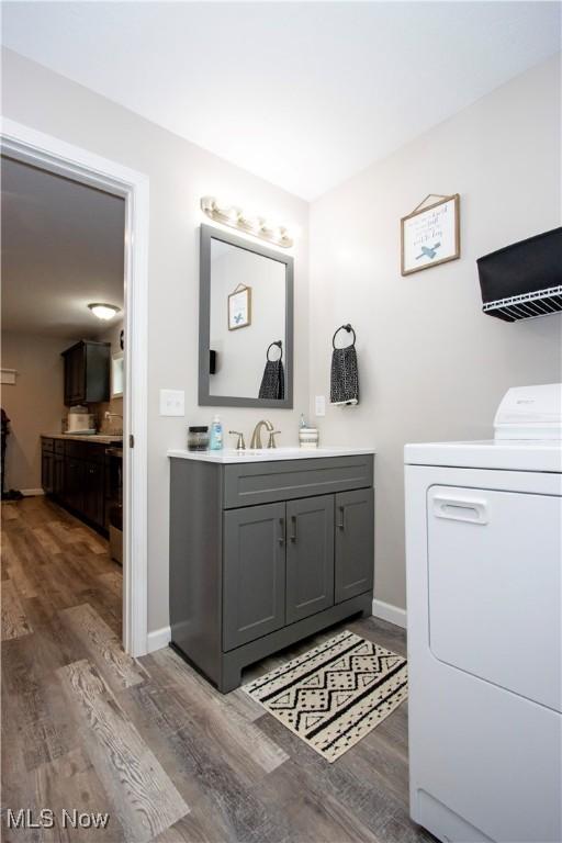 4234 Swigart Rd, Bellville, OH 44813 - bathroom with washer / dryer, wood finished floors, and vanity