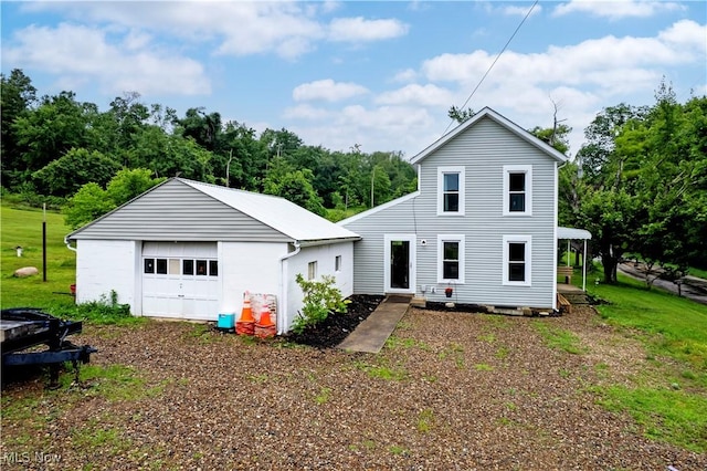 4234 Swigart Rd, Bellville, OH 44813 - rear view of property featuring a garage, an outbuilding, and a yard