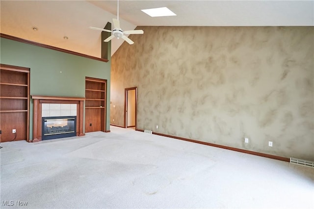 1977 Fox Trace Trl, Cuyahoga Falls, OH 44223 - unfurnished living room with ceiling fan, a tiled fireplace, carpet floors, and high vaulted ceiling