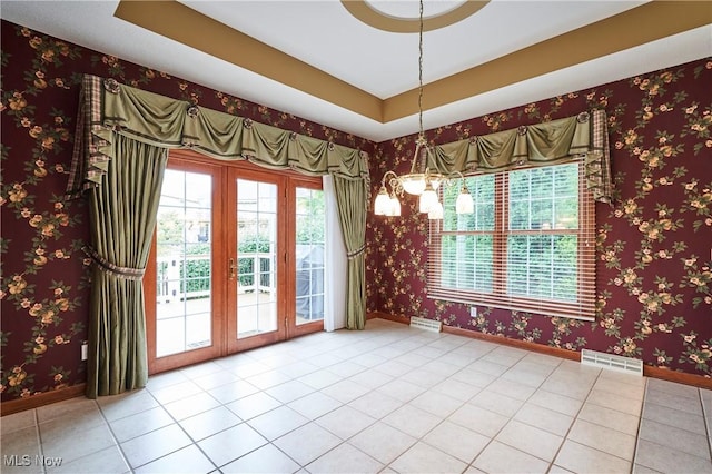1977 Fox Trace Trl, Cuyahoga Falls, OH 44223 - unfurnished dining area with tile patterned flooring, a chandelier, and french doors