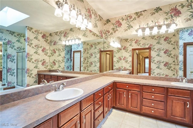 1977 Fox Trace Trl, Cuyahoga Falls, OH 44223 - full bathroom featuring a skylight, double vanity, wallpapered walls, and tile patterned floors