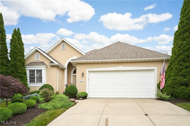1977 Fox Trace Trl, Cuyahoga Falls, OH 44223 - traditional-style home with stucco siding, concrete driveway, and an attached garage