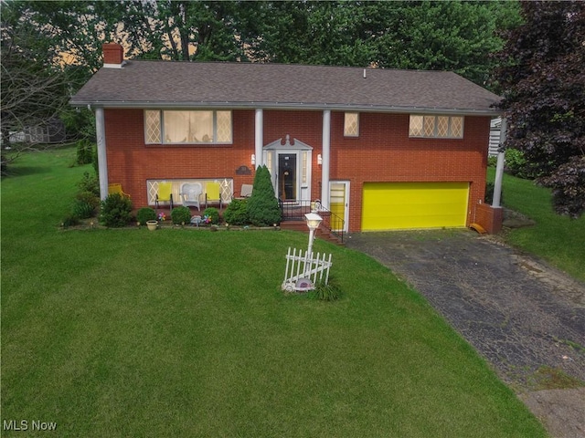 311 Hilda Cir, Bloomingdale, OH 43910 - raised ranch with asphalt driveway, brick siding, an attached garage, a chimney, and a front yard