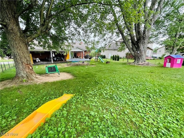 311 Hilda Cir, Bloomingdale, OH 43910 - view of green lawn with a playground and a trampoline