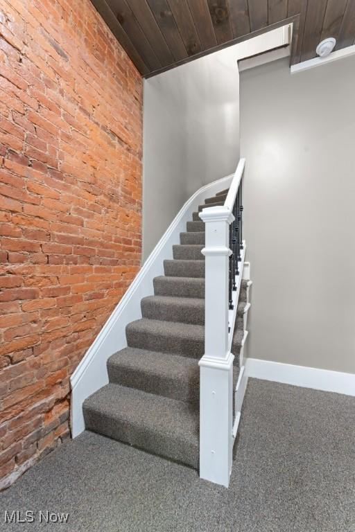 638 High St, Wooster, OH 44691 - stairway featuring brick wall, carpet flooring, and wooden ceiling